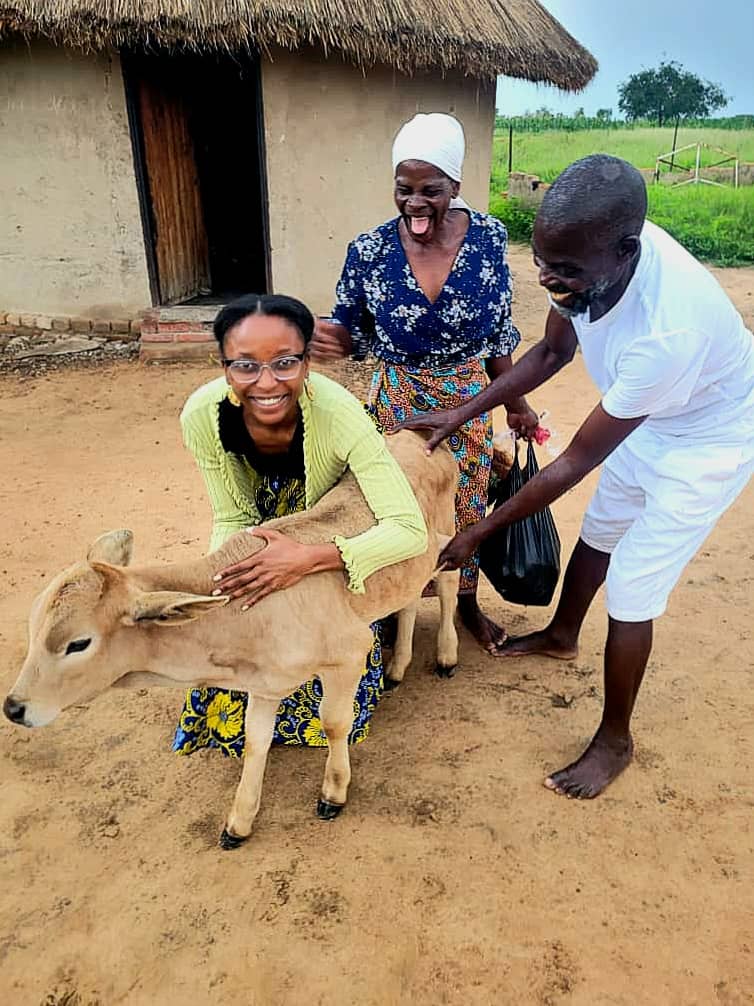 Meet "Lady." Amanda naming a young calf, whose mother recently passed away during childbirth, as a result of malnutrition. 